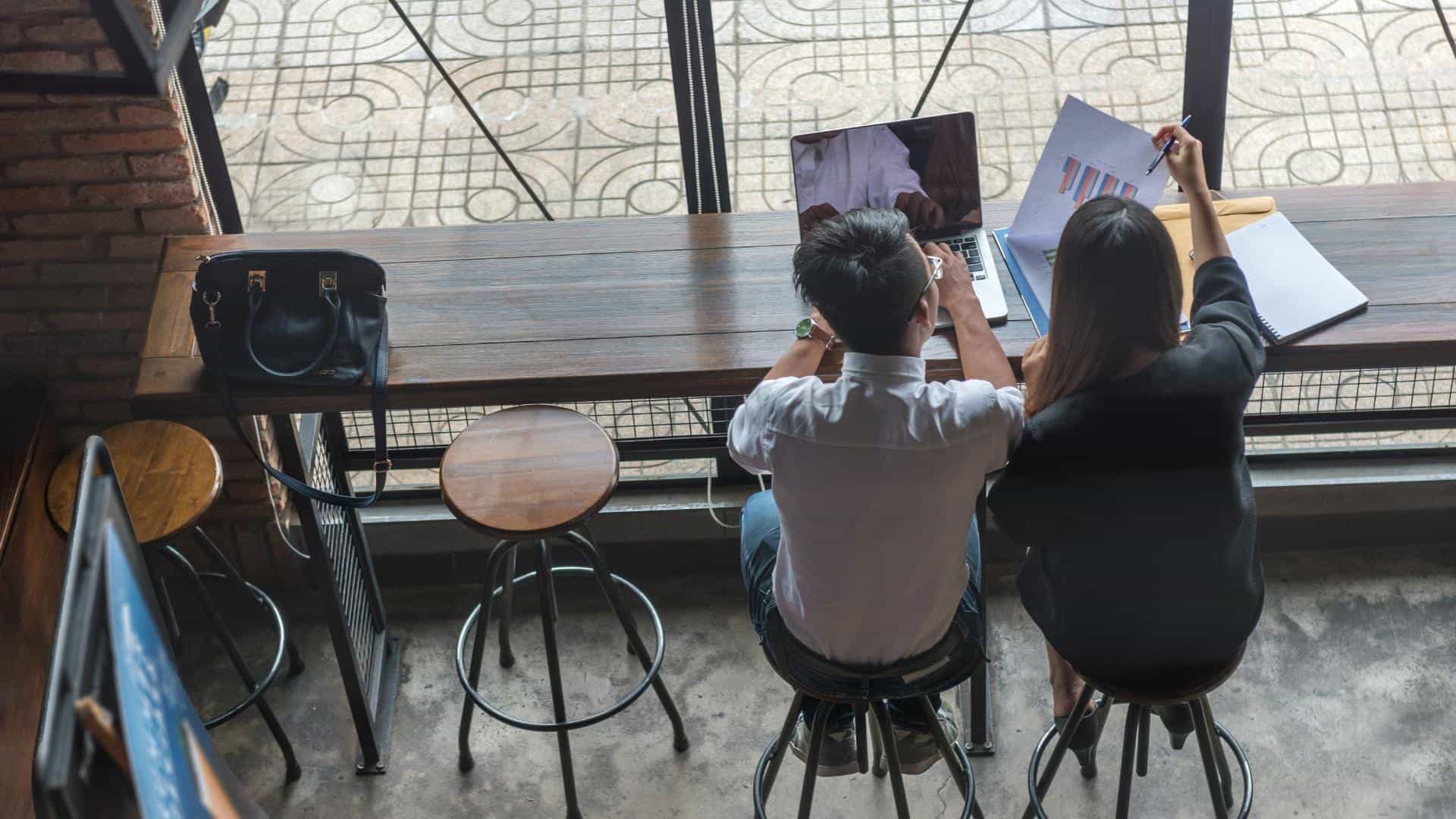 Two people collaborating in a coffee shop